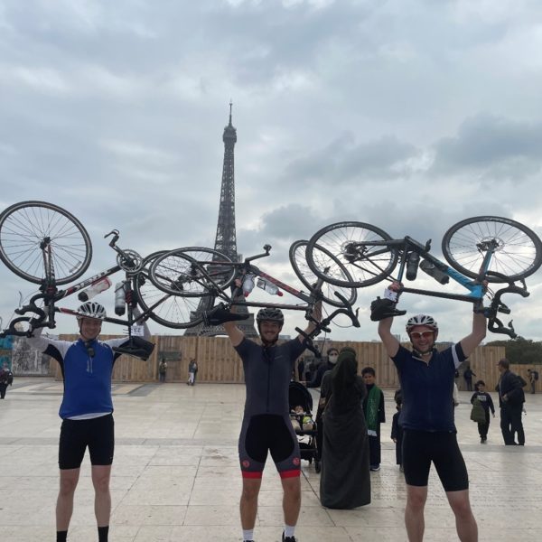 Finders Keepers team holding up bikes in front of Eiffel Tower